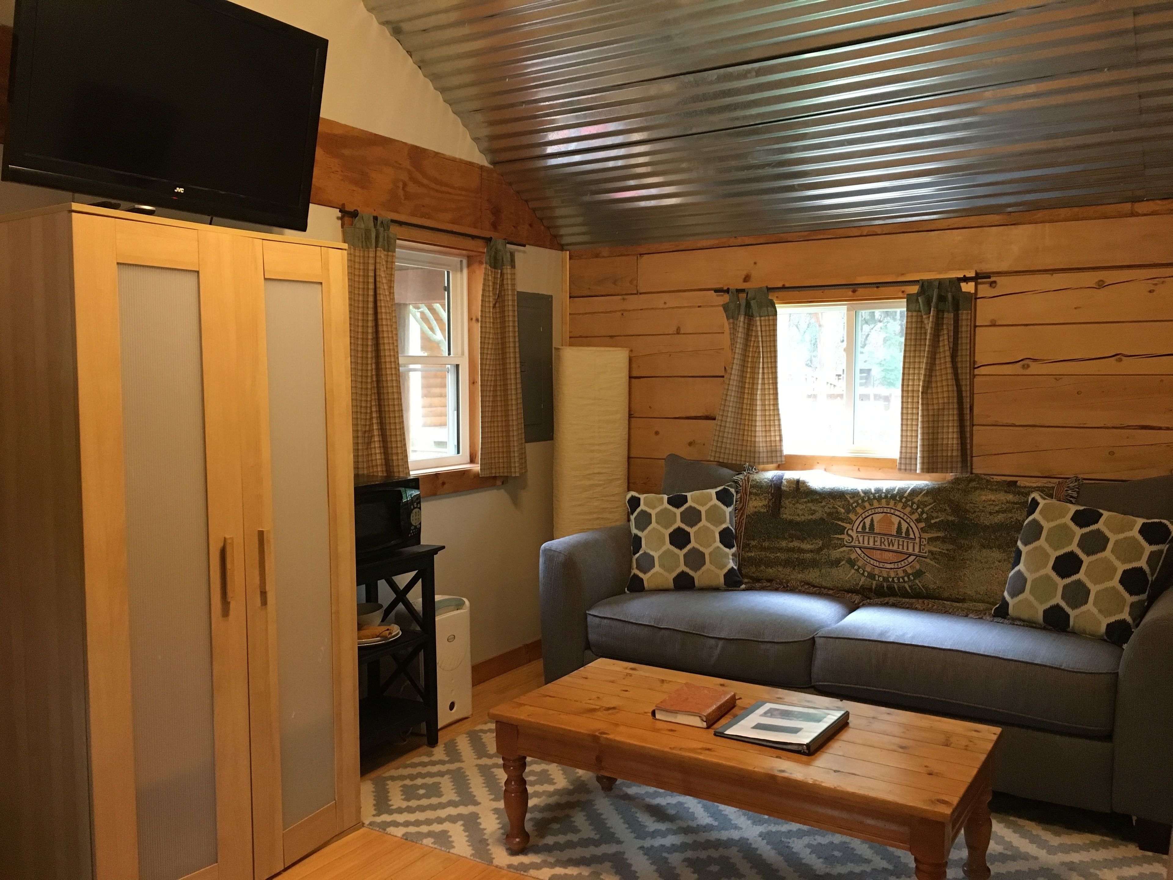 comfort cabin, 1 queen bed with sofa bed, refrigerator & microwave, ground floor | living area | 50-inch smart tv with digital channels, tv, streaming services