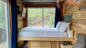 A cozy cabin-style room with a loft bed, a desk, and a chair. - Barefoot Hills (Dahlonega)