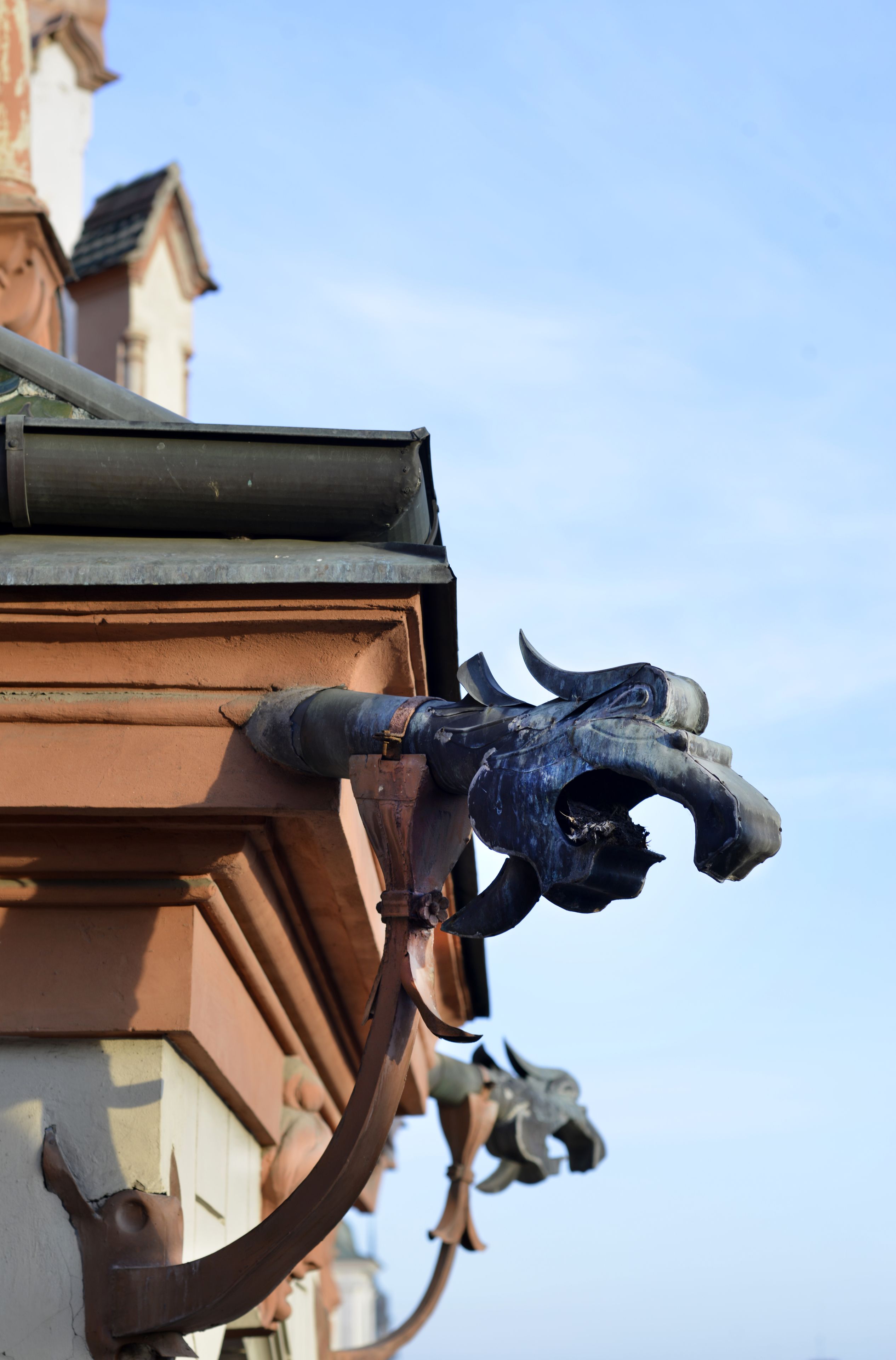 A building corner with a decorative metal sculpture of a bull's head.
