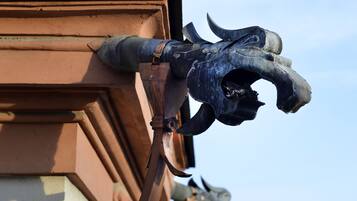 A building corner with a decorative metal sculpture of a bull's head.