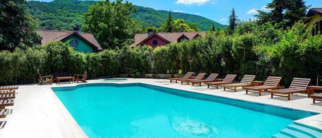 Seasonal outdoor pool, open 7:00 AM to 8:00 PM, pool umbrellas