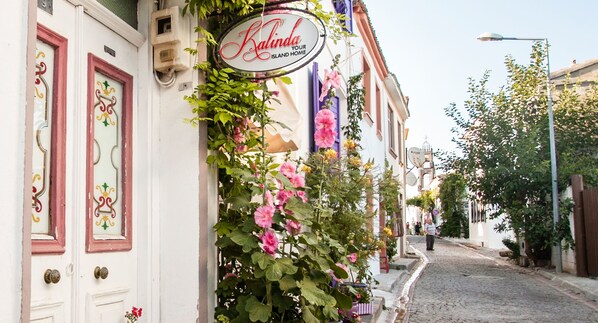 Una calle con un edificio que muestra un letrero que dice "Kalinda Your Island Home".