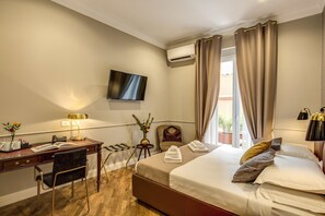 A hotel room with a bed, desk, chair, TV, and a window with curtains. - Charme Spagna Boutique Hotel (Rome)