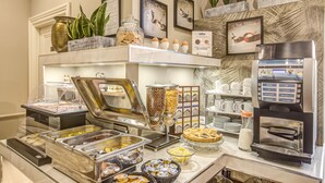 Een buffetruimte met diverse gerechten, een koffieapparaat en decoratieve wandelementen.