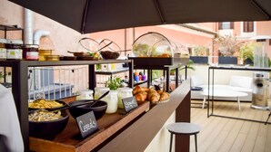 A breakfast buffet with various food items and a coffee station. - MyTALE Creative Academy Hotel (Rome)