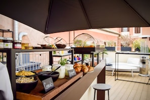 A breakfast buffet with various food items and a coffee station. - MyTALE Creative Academy Hotel (Rome)