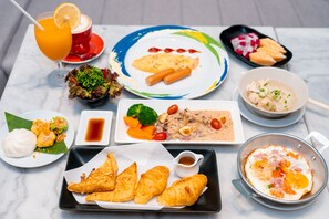 A variety of dishes including sushi, a bowl of soup, and a plate of croissants. - Amanta Hotel & Residence Ratchada (Bangkok)