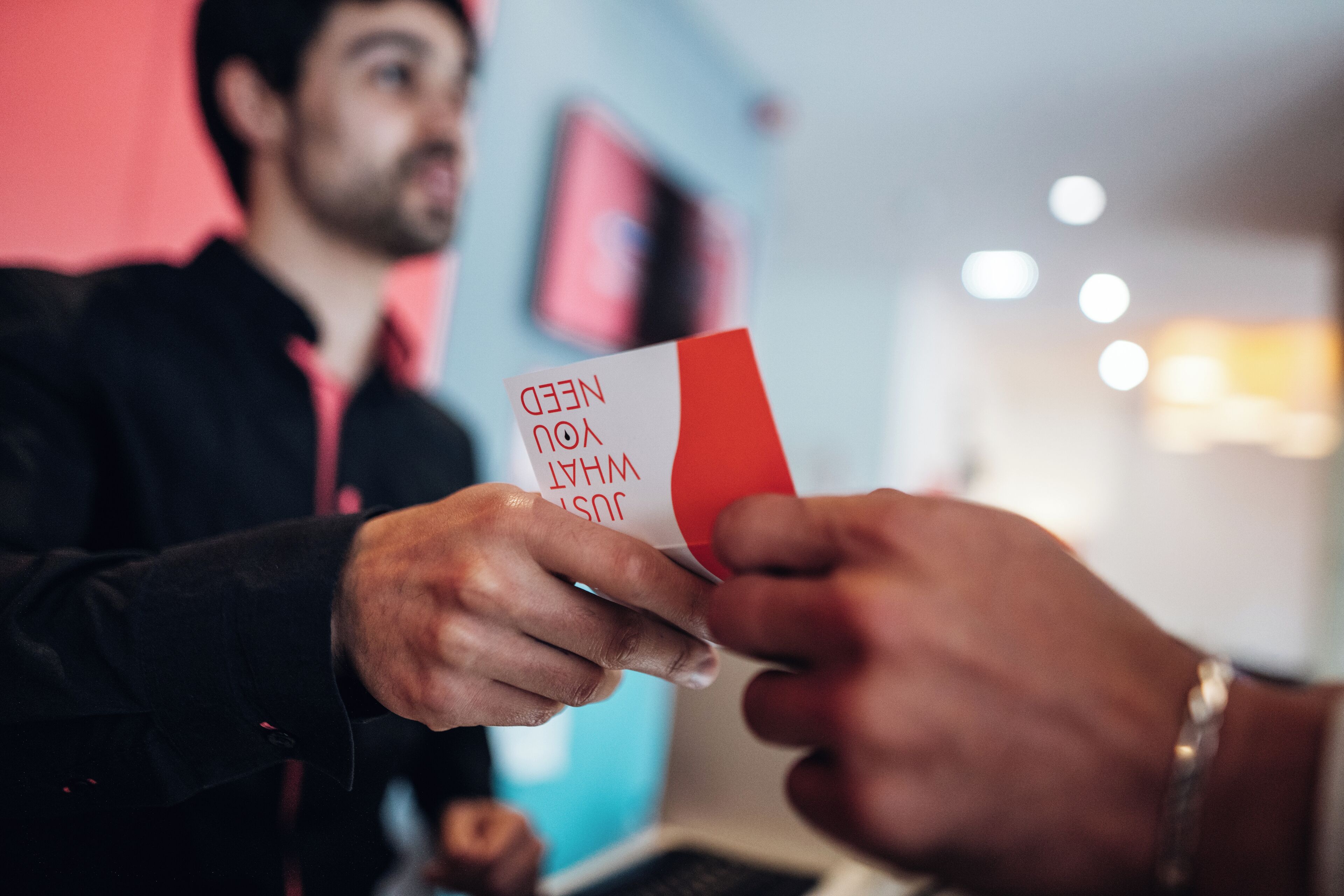 A person holding a card with text.