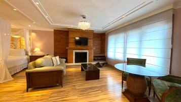 Romantic Studio Suite | Living area | 32-inch LCD TV with cable channels, TV