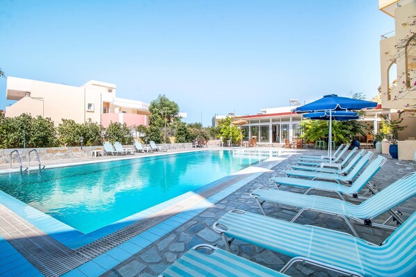 Seasonal outdoor pool, pool umbrellas, pool loungers