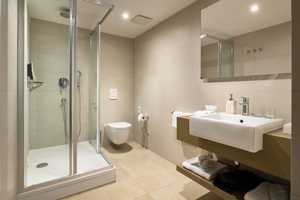 A modern bathroom with a glass-enclosed shower, a white sink, and a toilet. - TUI BLUE Adriatic Beach - Adults Only - All Inclusive (Podgora)