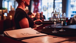 A bar setting with a bartender, glasses, and menus on the counter. - BOMA easy living hotel By Stay Collection (Strasbourg)
