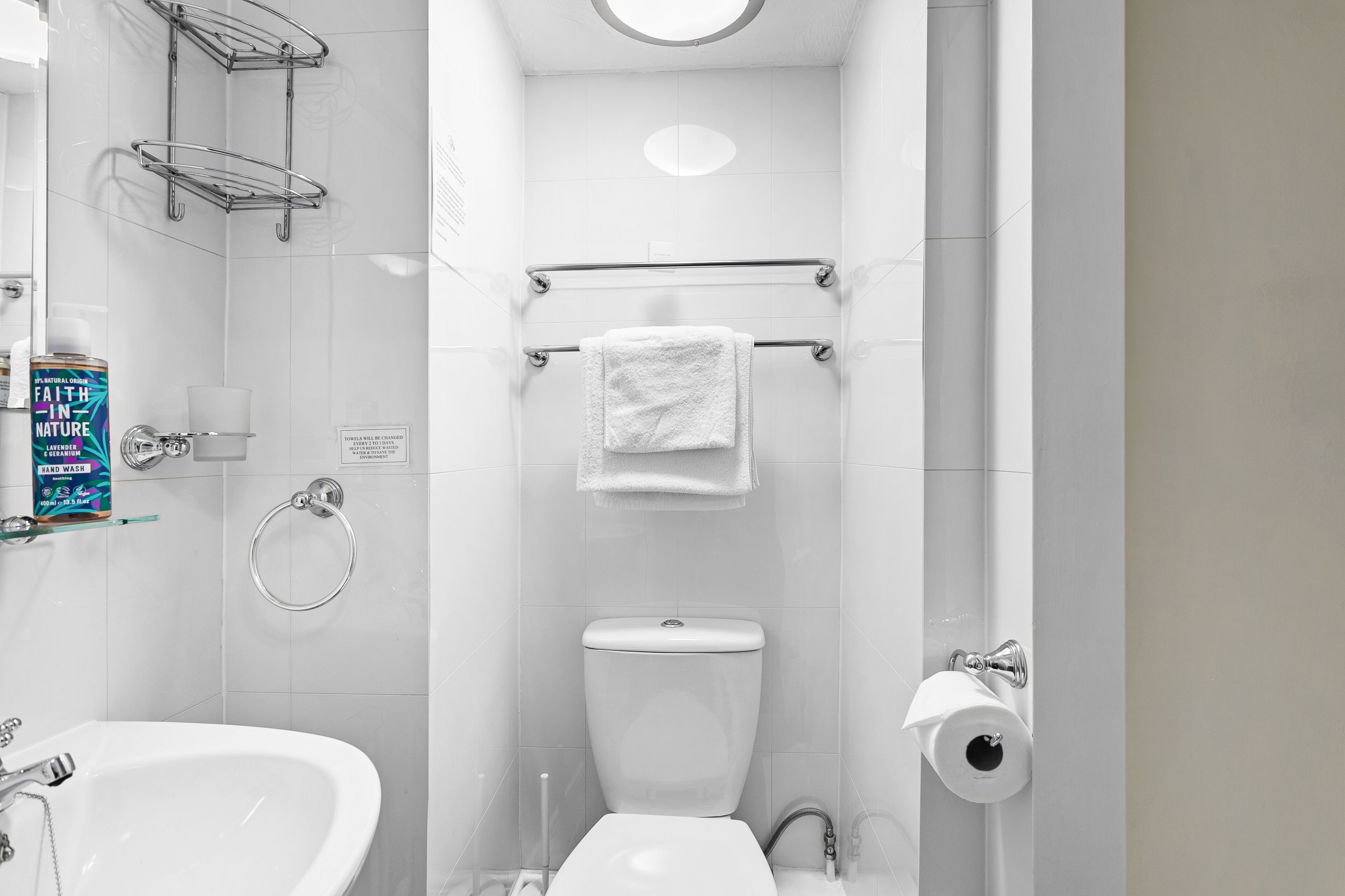 A modern bathroom with a toilet, bidet, and a sink.