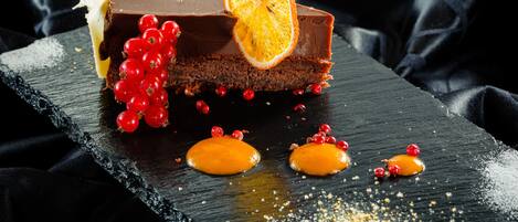 Un postre sobre una tabla de pizarra con fondo oscuro.