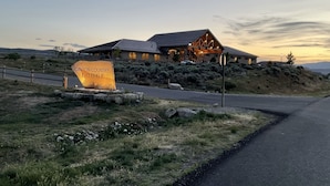 A lodge with a prominent sign reading "Canyon Country Lodge" in a natural setting with a road leading to it. - Canyon Country Lodge (Escalante)