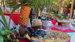A table with various food items, including fruits, vegetables, and condiments, set up outdoors. - Hacienda del Lago Boutique Hotel (Ajijic)