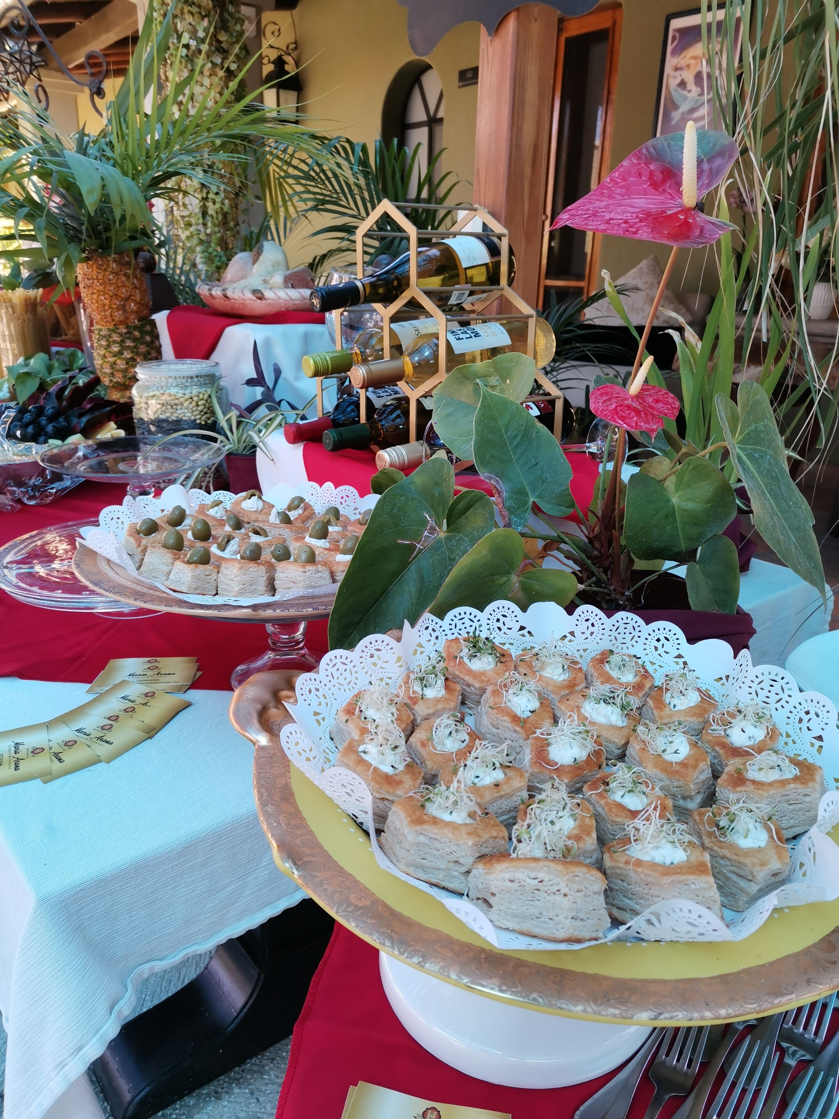 A table with various food items, including pastries and a pineapple.