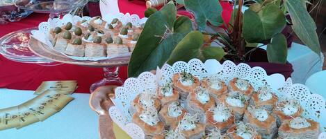A table with various food items, including pastries and a pineapple.