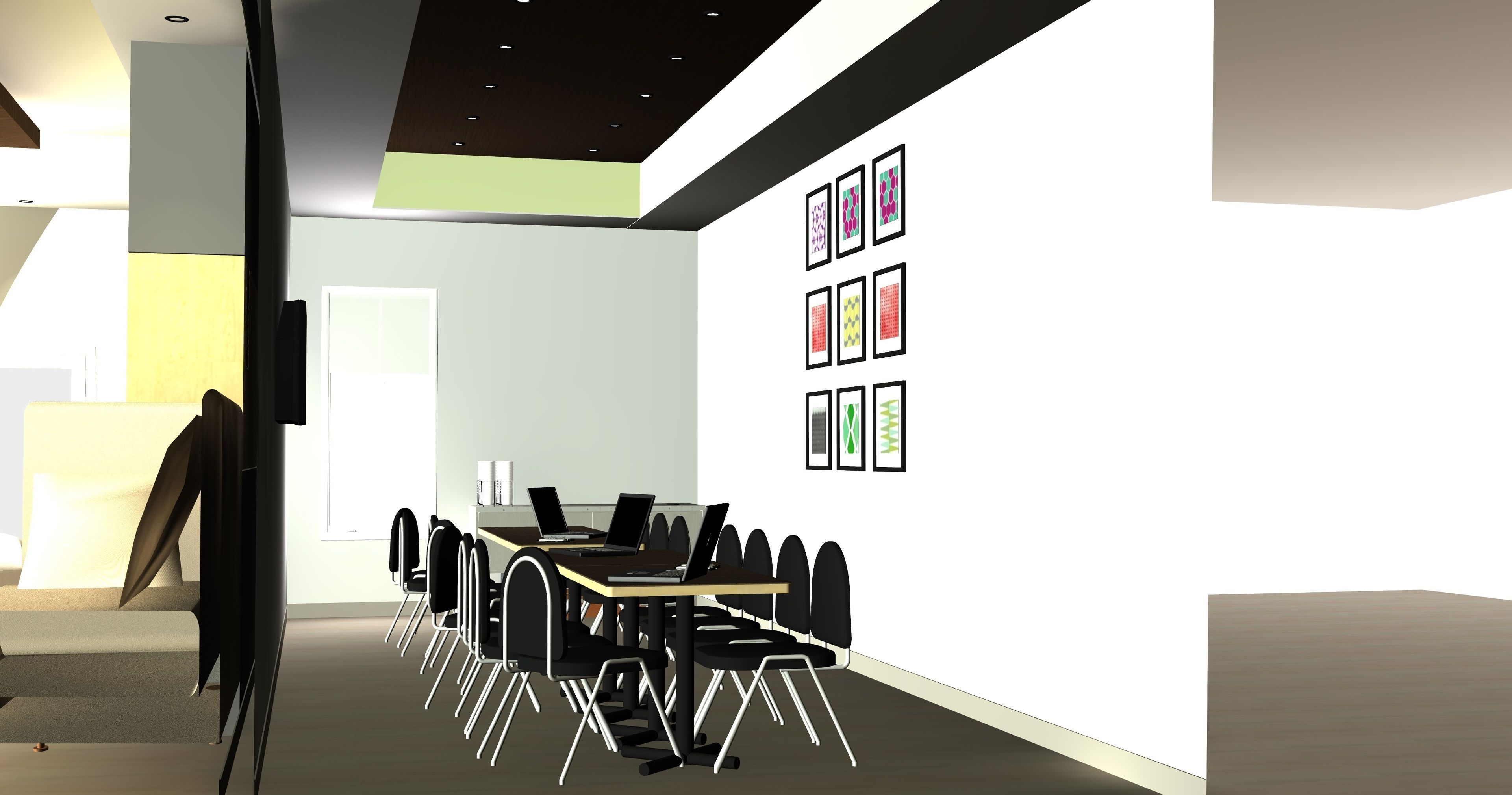 Une salle de conférence moderne, dotée d’une longue table, de chaises noires et d’ordinateurs portables.
