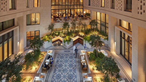 A multi-story hotel with a central atrium, outdoor seating areas, and a patterned floor. - Mandarin Oriental, Doha (Doha)