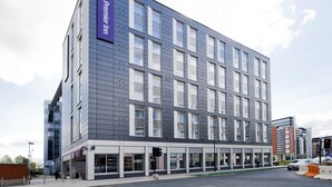 A modern hotel building with a prominent Premier Inn sign, large windows, and a flat facade. - Premier Inn Leeds Cc - Whitehall Road (Leeds)