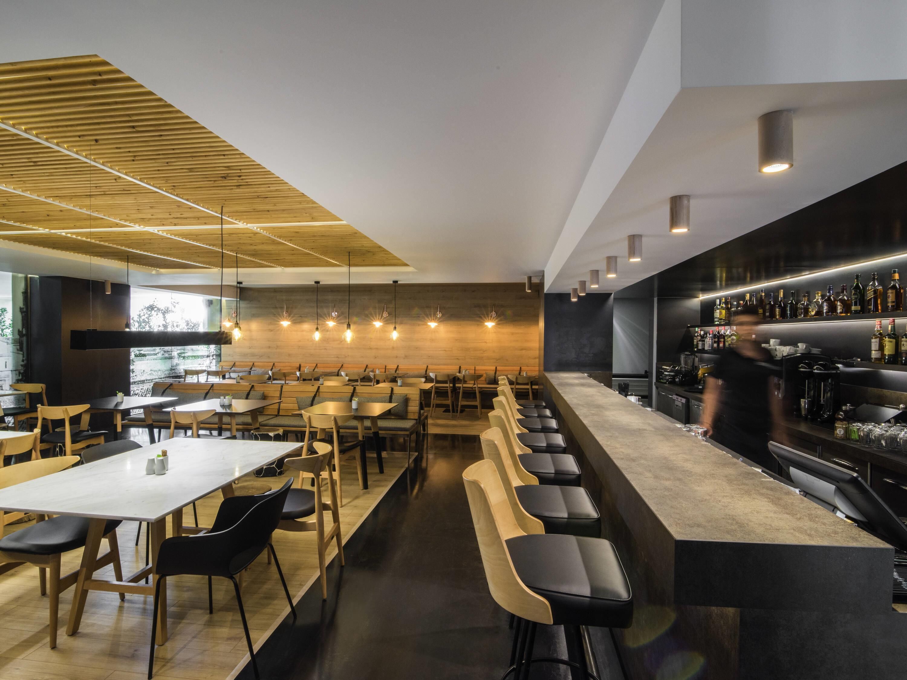 A modern bar area with seating and a bar counter.