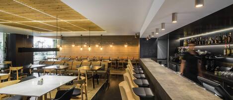A modern bar area with seating and a bar counter.