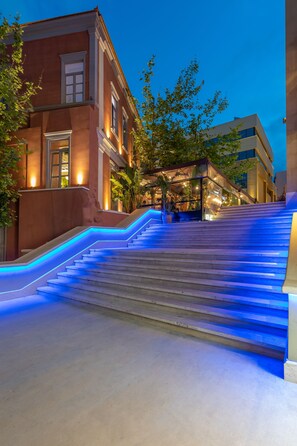 A staircase with blue lighting leading to a building entrance. - Ibis Styles Heraklion Central (Heraklion)