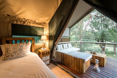 In-room safe, desk, bed sheets. Rukiya Safari Camp