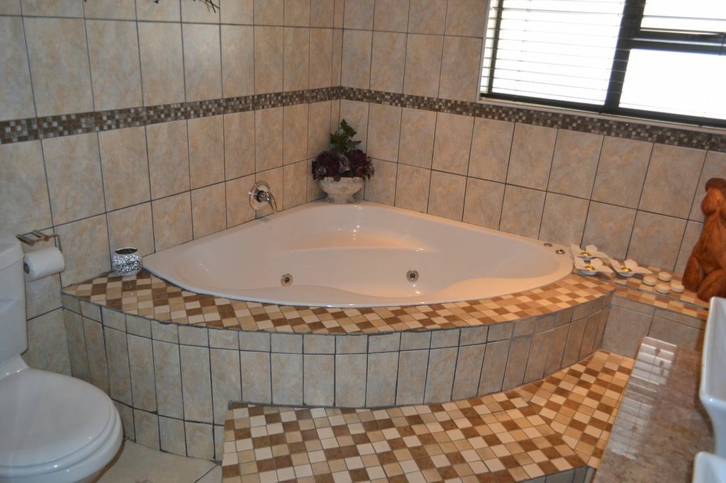 Un baño con una bañera independiente, inodoro y lavamanos.