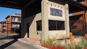 A building with a stone facade and a sign reading "The Village."