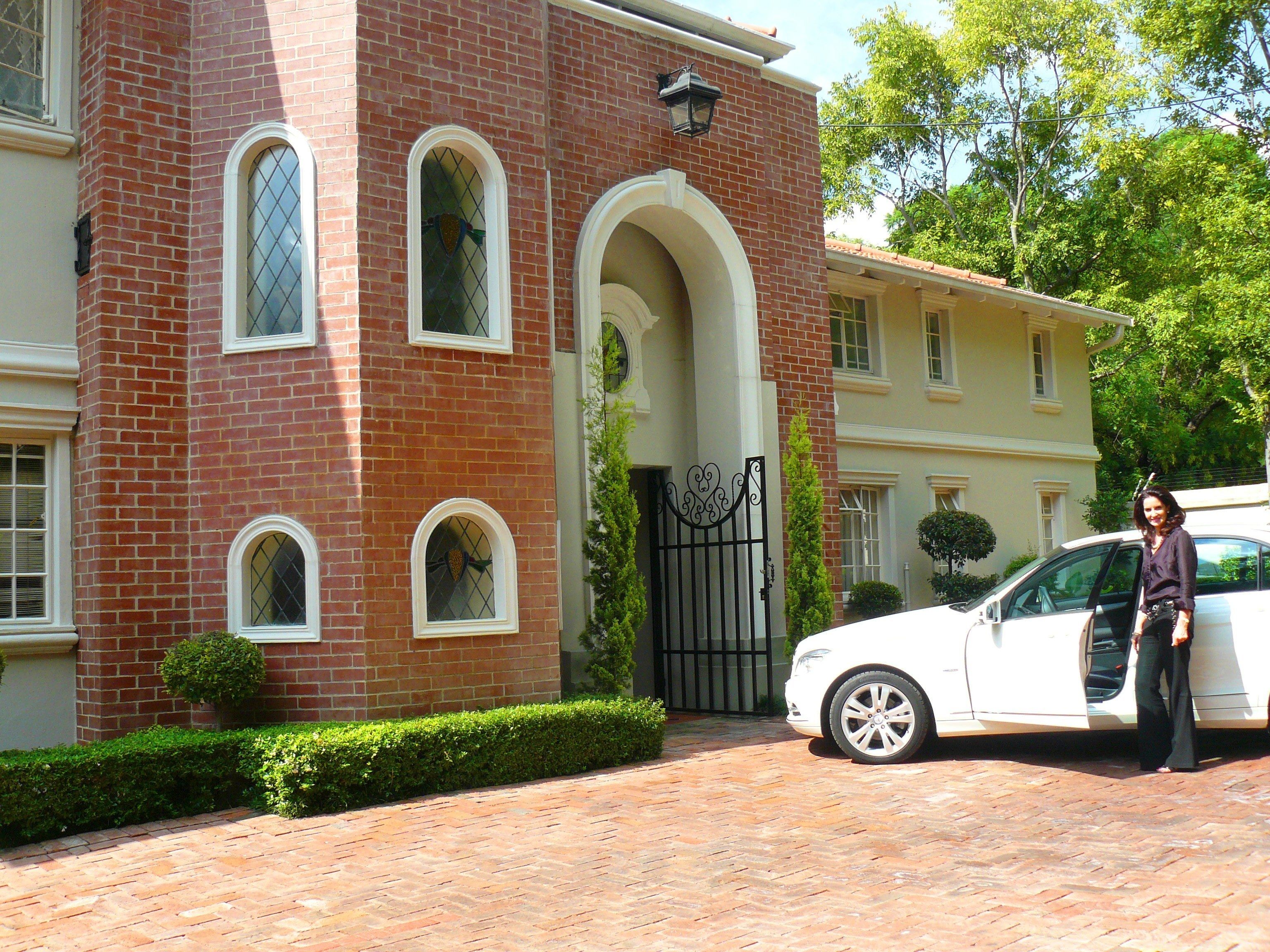 A brick building with arched windows and a gated entrance.