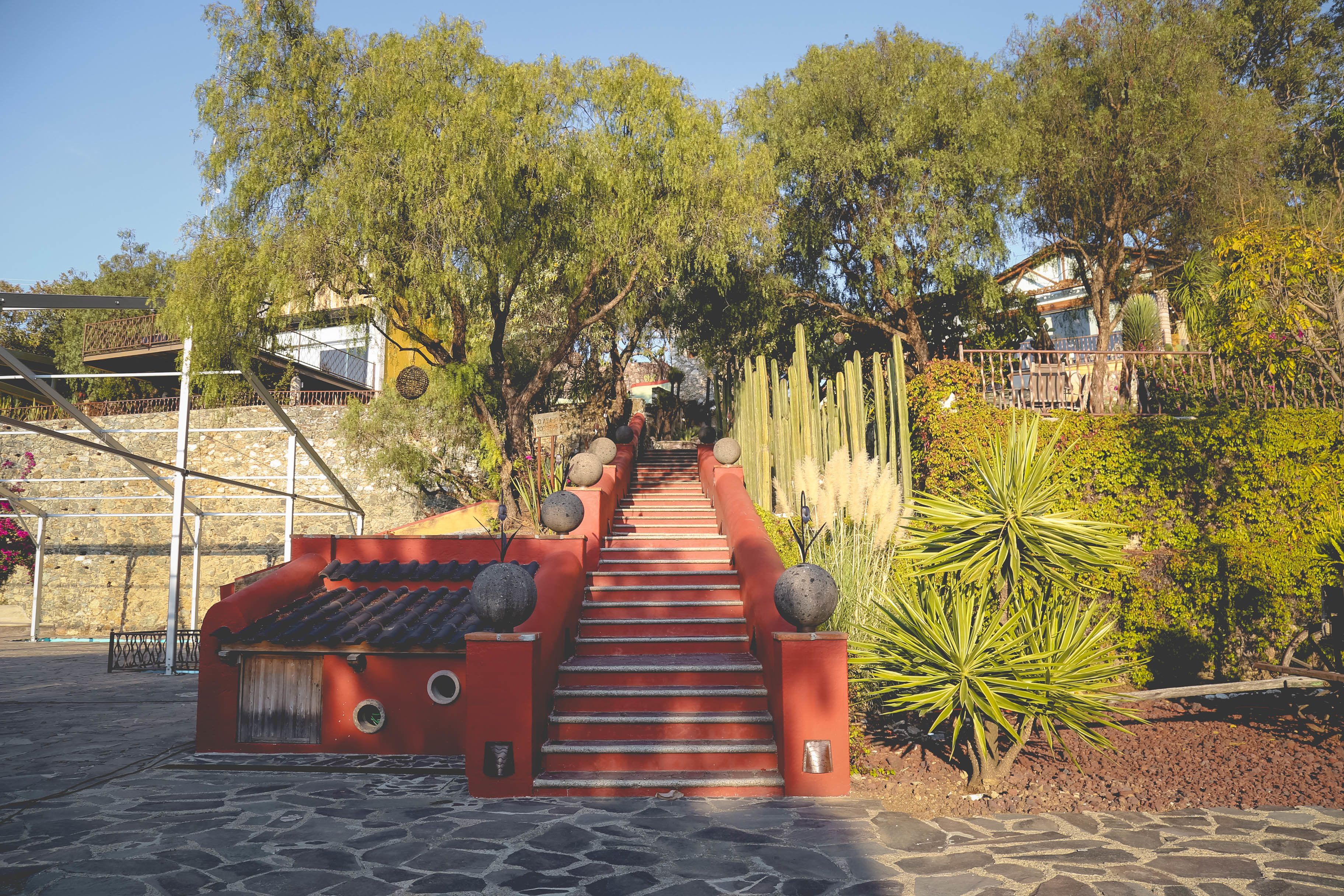 A staircase leading up to a building with a red exterior and stone steps.