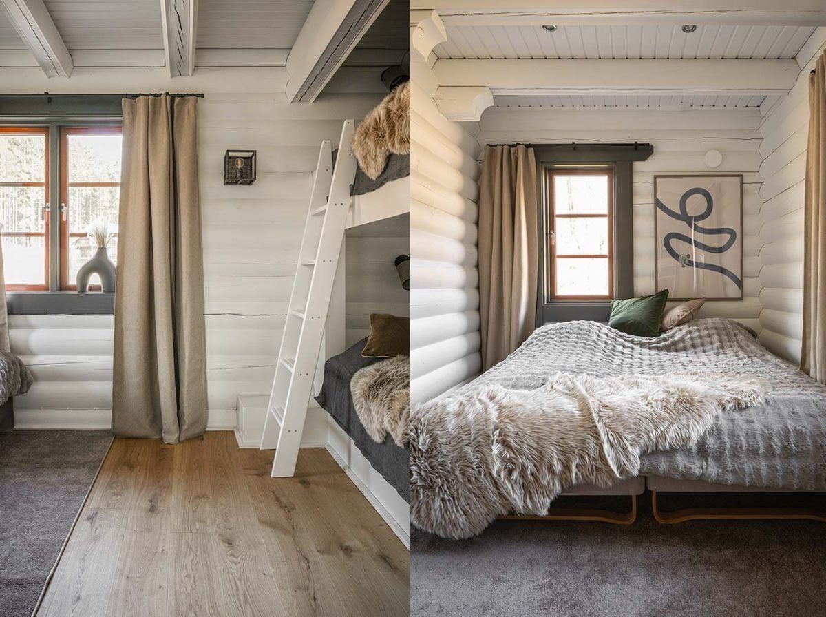 Une chambre dans une cabane en rondins, avec un lit en mezzanine, une échelle, une grande fenêtre et un tableau encadré au mur.