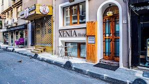 A hotel named XENIA with a wooden door and a sign indicating it is in Istanbul. - Xenia Hotel (Istanbul)