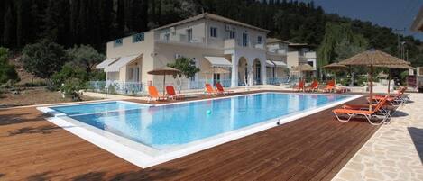 Seasonal outdoor pool, pool umbrellas, pool loungers