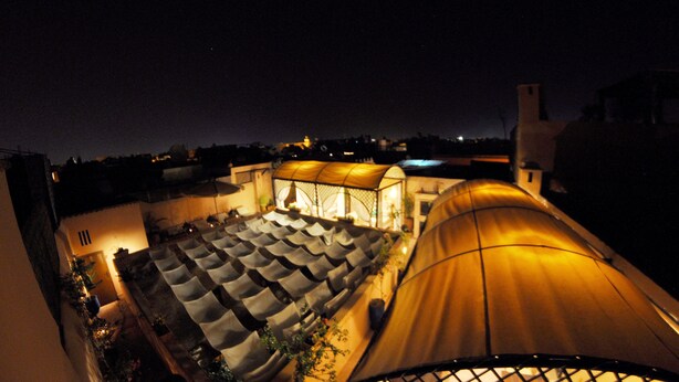 A rooftop terrace with a covered seating area and a large tent-like structure. - Riad Hidden (Marrakech)