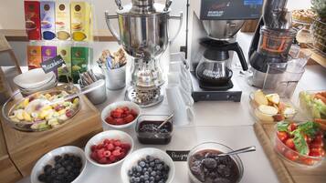 A buffet setup with various food items and a coffee machine.