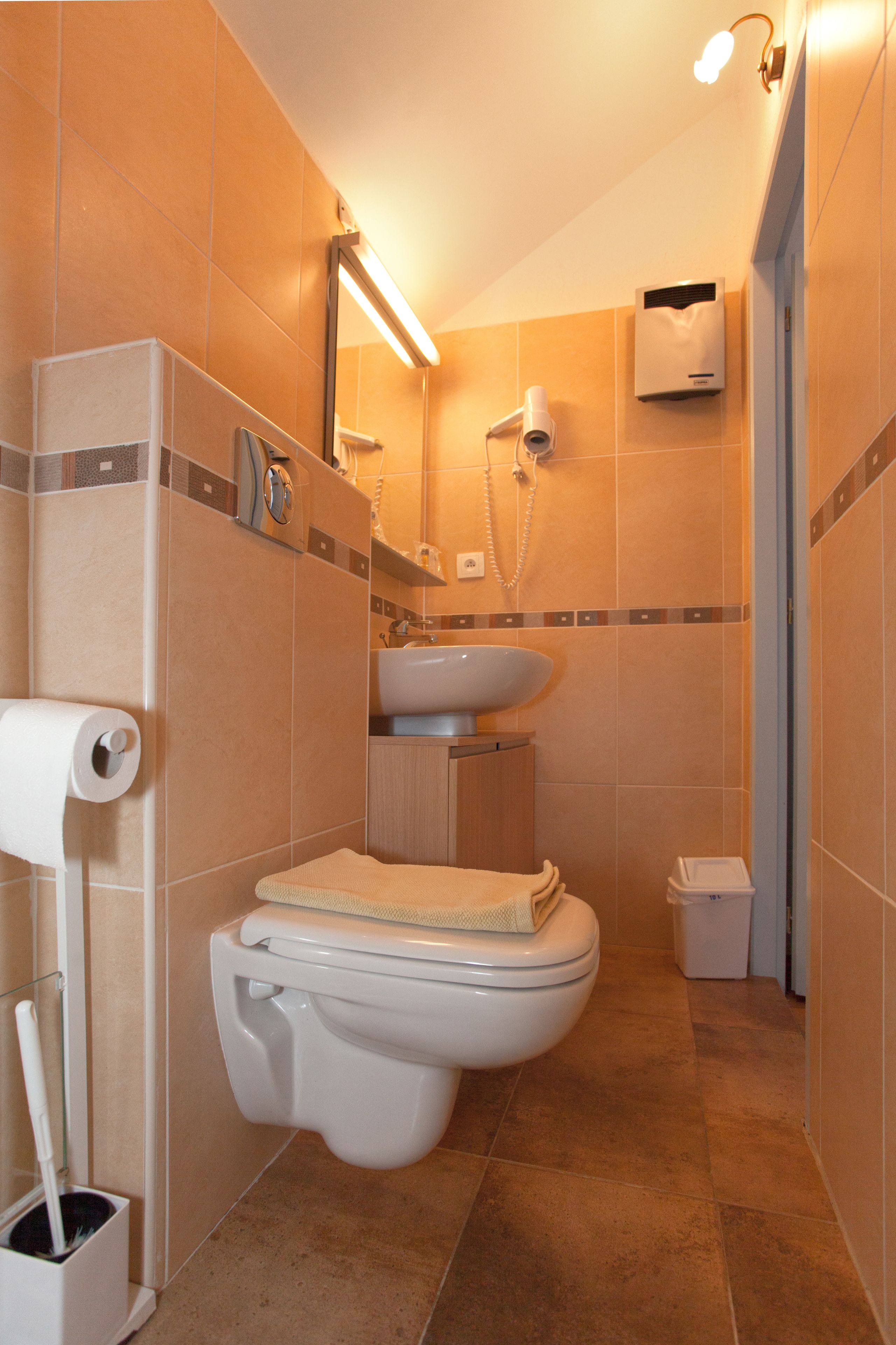 Un baño con inodoro, lavamanos y ducha.