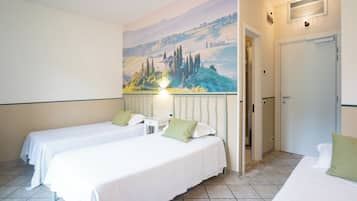 A hotel room with two beds, a painting of a landscape on the wall, a door, and a small table.