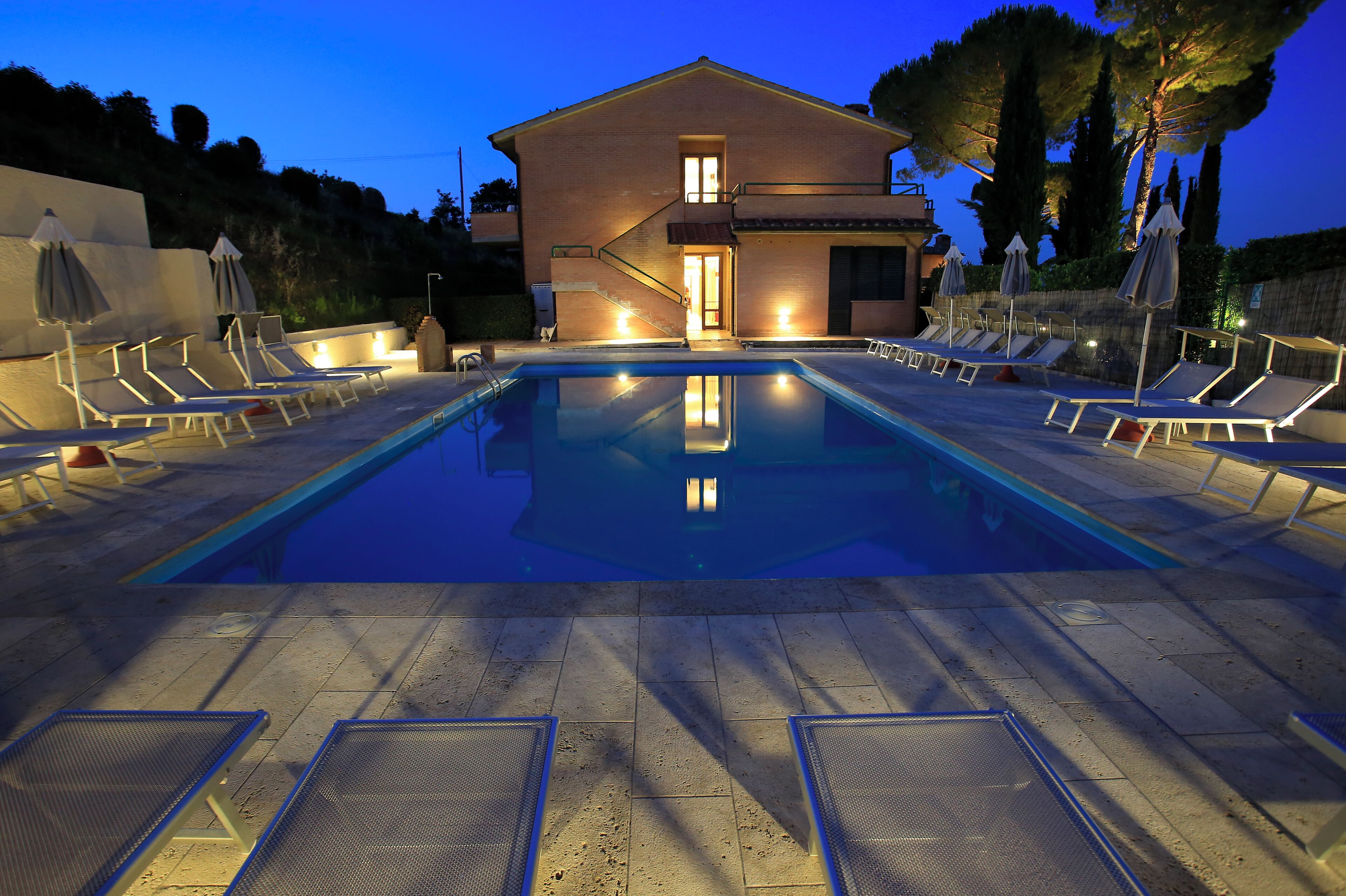 Seasonal outdoor pool, open 7:30 AM to 8:00 PM, pool umbrellas