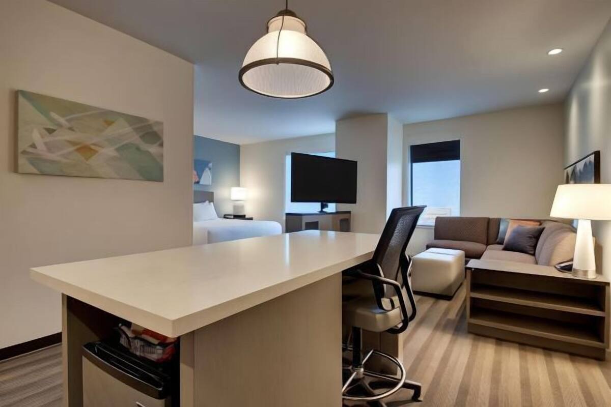 Hypo-allergenic bedding, desk, laptop workspace, blackout drapes