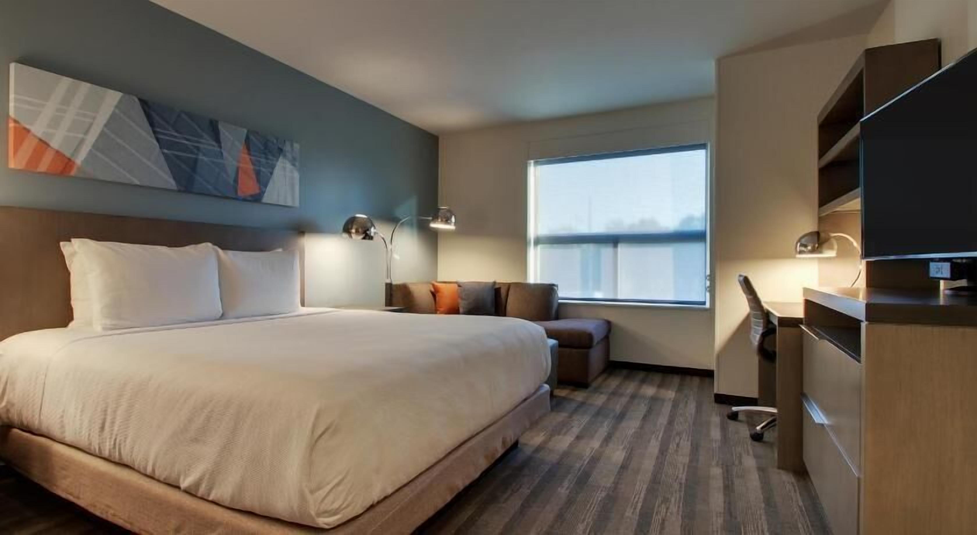 Hypo-allergenic bedding, desk, laptop workspace, blackout curtains