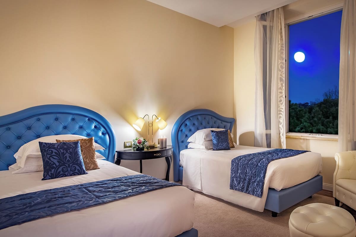 Suite junior, varias camas, no fumadores, baño privado | Ropa de cama de alta calidad, minibar, caja fuerte y escritorio