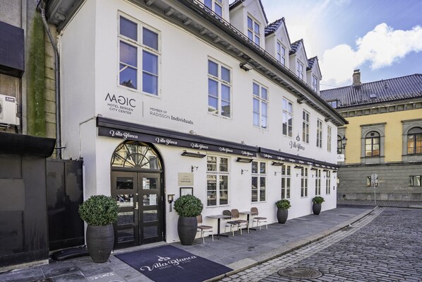 A white building with a black awning, a sign for 'Villa Blanca,' and outdoor seating. - Magic Hotel Bergen City Center, a member of Radisson Individuals (Bergen)