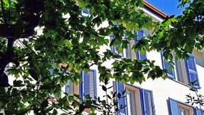 Un edificio con contraventanas azules y paredes blancas.
