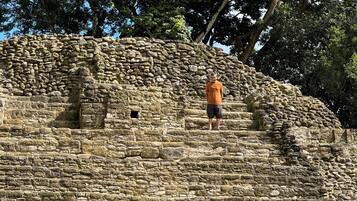 A stone structure with a person standing on it.