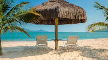 On the beach, sun loungers, beach umbrellas, beach towels