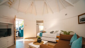 A modern living room with a television, sofa, and coffee table. - Surf Motel (eMdloti)