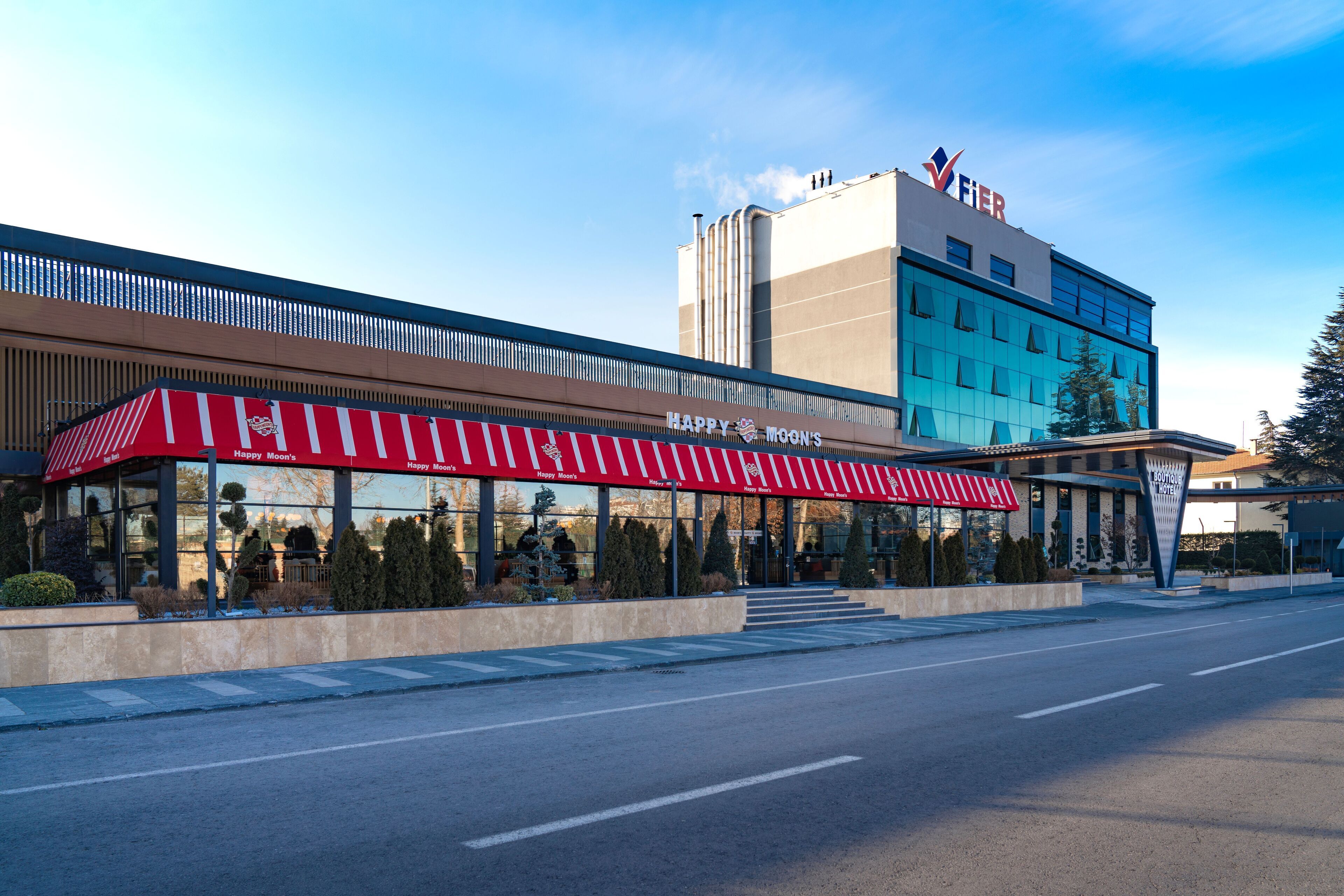 A hotel with a red awning and a sign that reads "Happy Moon's."
